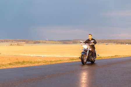 Man riding a motorcycle on the country roadの写真素材
