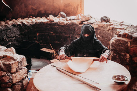 HURGHADA, EGYPT - MAY 18, 2015: Old Arab woman prepares bread in a Bedouin villageのeditorial素材