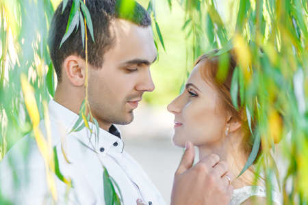Young casual couple enjoy of each other under treeの写真素材