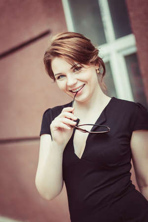 Close-up of beautiful brunette model in stylish sunglasses. Young pretty female posing outdoorsの写真素材