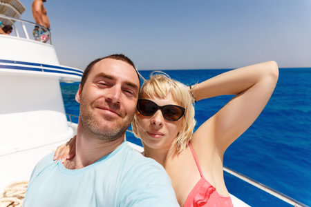 Cruise ship couple taking selfie self portrait photo romantic. Happy lovers, woman and man traveling...