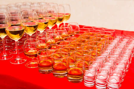 glasses with beverages on the banquet table, selective focusの写真素材