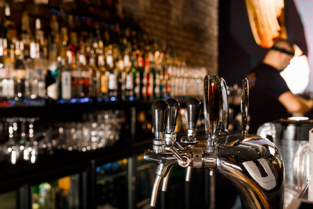 young man working as a bartender in a nightclub bar