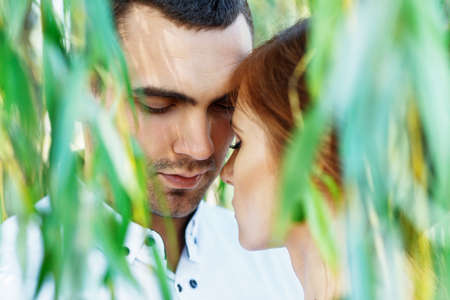 Young casual couple enjoy of each other under treeの写真素材