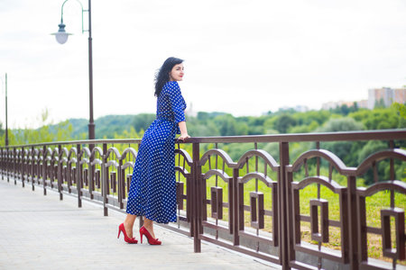 beautiful young brunette woman in blue dressの写真素材