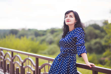 beautiful young brunette woman in blue dressの写真素材