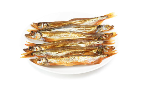 Plate with smoked capelin isolated on white background