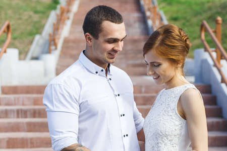 Beautiful woman with man at the stone wall embraceの写真素材