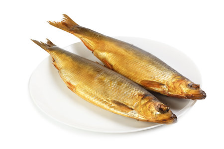 Hot smoked herring on plate isolated on a white backgroundの写真素材