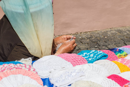 Woman crochets and sells  their products on the streetの写真素材