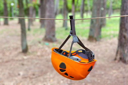 Climbing helmet hanging on the tense ropeの写真素材