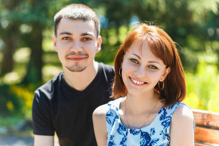 Nice young couple embracing in summer parkの写真素材