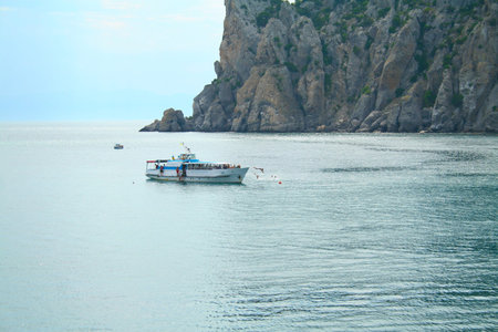 Unidentified people bathe on the yacht in the waters of the Black Sea near the Noviy Svet, Ukraine.の写真素材