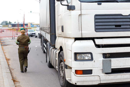 GRODNO, BELARUS - NOV 15: A female border guard checks the documents on Belarusian-Polish border line, November 15, 2013 in Grodno, Belarusのeditorial素材
