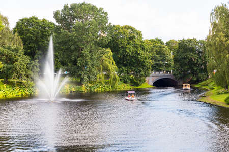 Boat makes a cruise on Riga channel in summer dayの写真素材