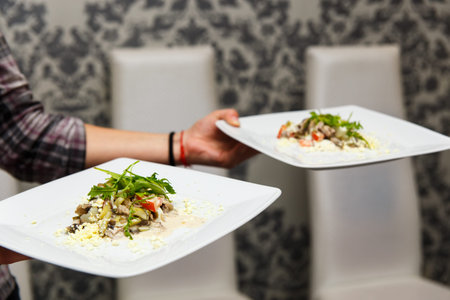 the waiter brought the salads on the Banquet tableの写真素材