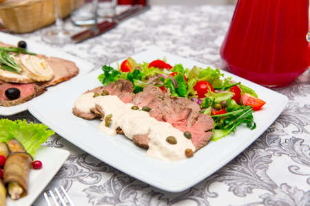 Dish with sliced meat products on the festive tableの写真素材