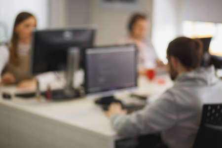 Blurred background picture with software developers during the working processの写真素材