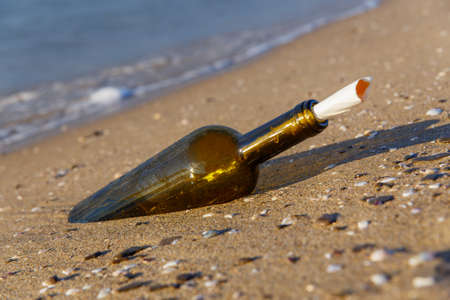 Message in a bottle on a sea shoreの写真素材
