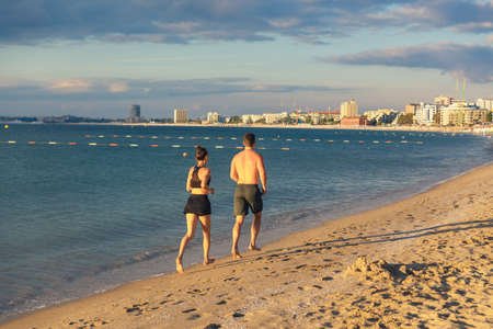 Couple Running Outdoors on Beach. Concept imageの写真素材