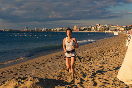 NESSEBAR, BULGARIA - SEP 02: Young woman running outdoors on morning beach in Nessebar, Bulgaria at September 02, 2016のeditorial素材