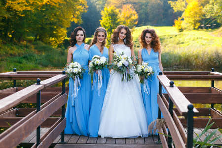Bride with bridesmaids on the park on the wedding dayの写真素材