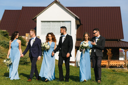 Groomsmen and bridesmaids walking on wedding ceremony