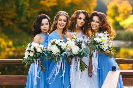 Bride with bridesmaids in the park on the wedding dayの写真素材