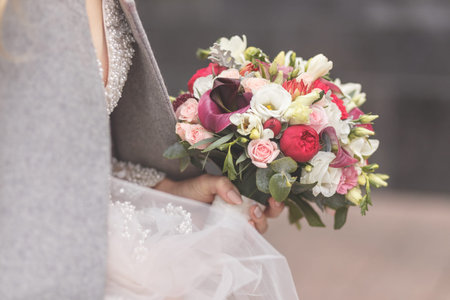 Beautiful wedding bouquet in hands of the bride