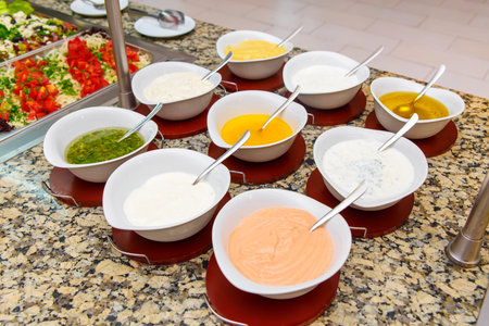 Fresh condiments and sauces on buffet in hotel restaurant