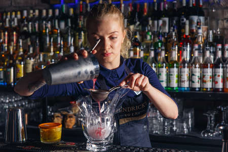 GRODNO, BELARUS - NOV 05: Woman bartender making an alcohol cocktail at the gastrobar HOUDINI in Grodno, Belarus, November 5, 2016のeditorial素材