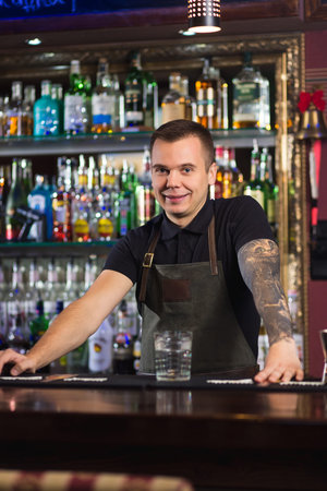 Beautiful stylish bartender posing in a barの写真素材