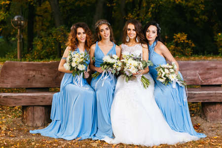 Bride with bridesmaids in the park on the wedding dayの写真素材
