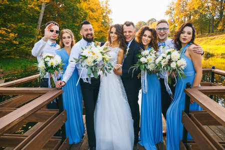 Newly married couple with groomsmen and bridesmaids posing on wedding ceremonyの写真素材