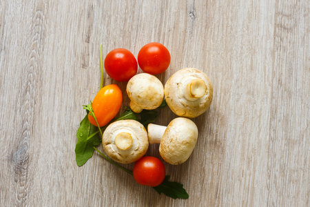 Ingredients for making pizza. Mushrooms, cherry tomatoes and arugulaの写真素材