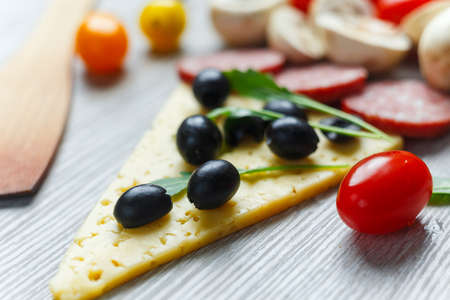 Creative composition of ingredients in the form of a slice of pizzaの写真素材