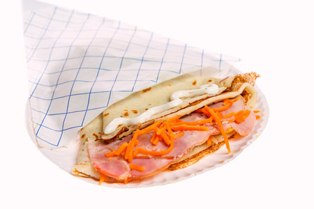 Pancake stuffed ham and cheese isolated on white backgoundの写真素材