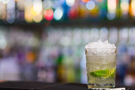 Misted over glass of Mojito cocktail on bar counter.の写真素材