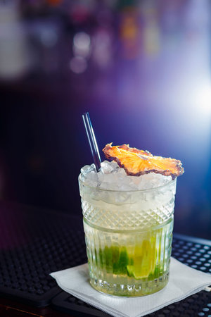 glass of mojito cocktail on bar counter in nightclubの写真素材