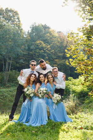 Groomsmen and bridesmaids having fun on wedding ceremonyの写真素材