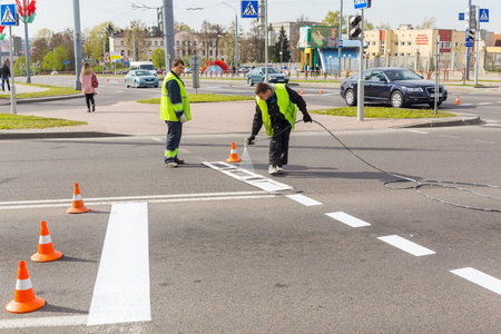 GRODNO, BELARUS - MAY 03, 2017: Workers applied road markings on urban streetのeditorial素材
