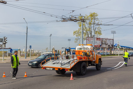 GRODNO, BELARUS - MAY 03, 2017: Workers applied road markings on urban streetのeditorial素材