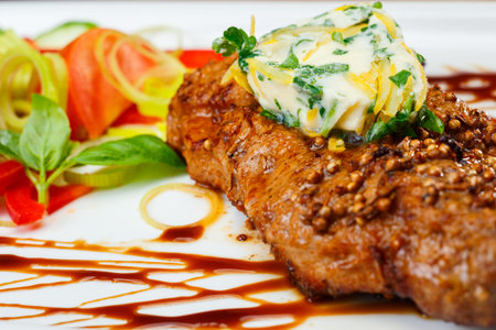 Rustic grilled beefsteak with french cheese an salad.の写真素材