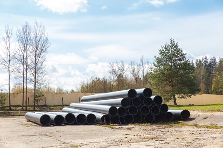 HDPE pipe for water supply stacked on the platform under the open sky