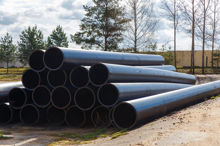 HDPE pipe for water supply stacked on the platform under the open sky