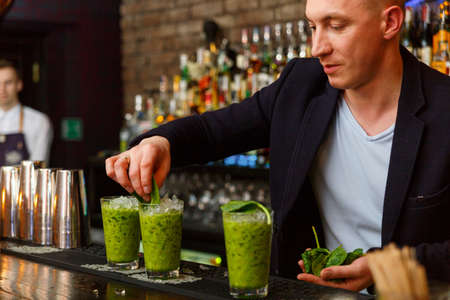 The bartender making vitamin cocktail in a nightclub barの写真素材