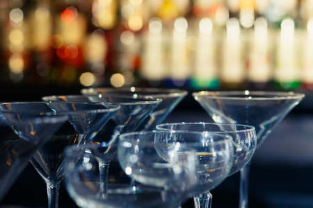 Lots of wine glasses on a bar counterの写真素材