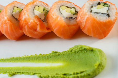 Salmon sushi rolls with shrimps on a black stone plate.の写真素材