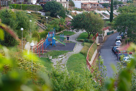 Nessebar, Bulgaria - August 30, 2016: Young man working out early morning on the street playground...