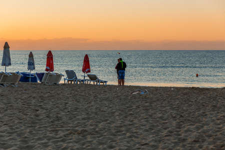 NESSEBAR, BULGARIA - SEP 02, 2016: Family meeting sun on a beach at sunrise in Nessebar, Bulgaria at September 02, 2016のeditorial素材